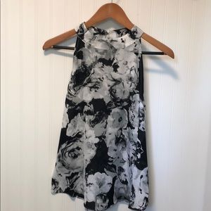Sleeveless black & gray floral blouse.